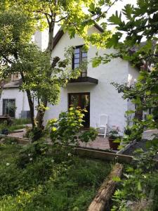 a white house with a chair on the porch at Aran House Lodge in Galway