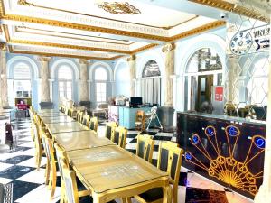 a dining room with tables and chairs in a building at VINBATH Check in in Nha Trang