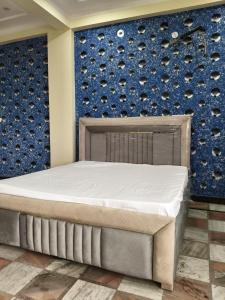 a bed in a room with a wall of wine bottles at After House South Luxe 8BHK Pool Estate in Jaipur