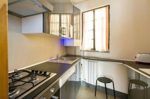 a small kitchen with a sink and a stove at Spagna Historical by Spanish Steps in Rome