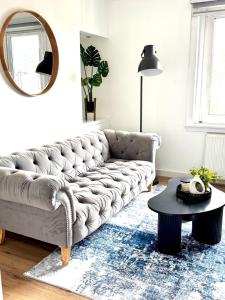 a living room with a couch and a table at Newtown Hideaway in Boʼness +35 photos