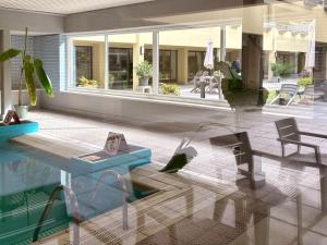 a house with a pool with a table and chairs at Studio terrasse in Middelkerke +51 photos
