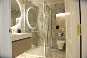 a bathroom with a shower and a sink and a toilet at Atlantic View - Portrush in Portrush +6 photos
