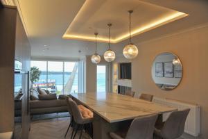 a dining room with a table and a couch at Atlantic View - Portrush in Portrush