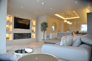 a living room with a couch and a tv at Atlantic View - Portrush in Portrush