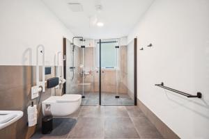 a bathroom with a toilet and a sink and a shower at Limehome Chemnitz Kirchgässchen in Chemnitz +43 photos