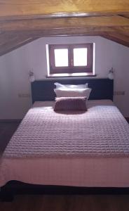 a bedroom with a large bed with a window at Spiti Ouranoupoli in Ouranoupoli