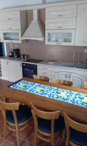a kitchen with a table with chairs and a sink at Spiti Ouranoupoli in Ouranoupoli +11 photos