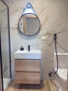 a bathroom with a sink and a mirror at J&C Arcade in Arcade +29 photos