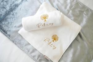 two napkins with trees on them sitting on a bed at Rebany Apartman 2 Free parking, Central Location in Debrecen