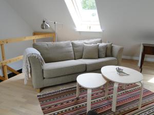 a living room with a couch and a table at Dyssegaard Holiday Apartment in Skallerup
