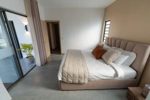 a bedroom with a large bed with white sheets and pillows at Mauritius in Midlands Station +41 photos