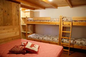 a room with three bunk beds in a cabin at Casa Chamonin in Gressan