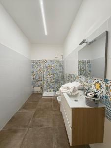 a bathroom with a sink and a toilet at San Tommaso in Ortona +27 photos