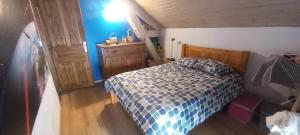 a bedroom with a bed with a blue and white comforter at tatou in Gap