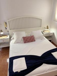 a bedroom with a white bed with two night stands at Villa Marta - Girona in Girona +40 photos