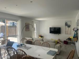 a living room with a couch and a table and chairs at 4 bedroom 4 bathroom villa 15 with pool and hot tub in Saint-Augustin