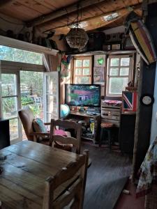 a living room with a table and a tv at Sigloxx in La Pedrera