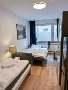 ein Zimmer mit zwei Betten und einem Fenster in der Unterkunft Apartment with kitchen, bed, sofa in Essen