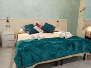 a bedroom with a large bed with towels on it at Le Nonne HOUSE - Assemini - free parking P in Assemini