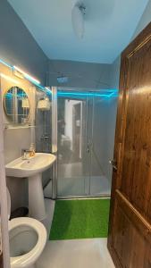 a bathroom with a shower and a toilet and a sink at Pannónia Rooms and Apartments in Satu Mare +116 photos