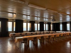 a large room with rows of tables and chairs at RPG Veľkokapacitné ubytovacie zariadenie in Gabčíkovo +3 photos