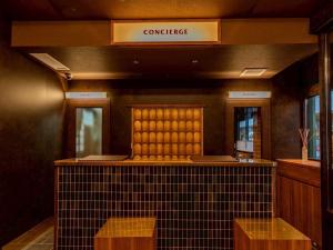 a restaurant with a counter and a sign that reads conference at HOTEL RELIEF Kokura Station in Kitakyushu