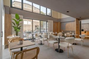 a restaurant with tables and chairs and windows at Rai Premium İstanbul in Istanbul