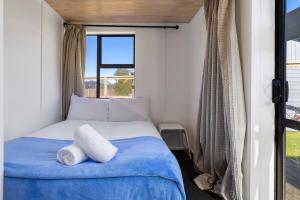 a bedroom with a bed and a window at Good times at the Lake in Mangakino