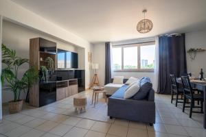 a living room with a couch and a table at Centre - Clim - Parking - Esplanade de l'Europe in Montpellier