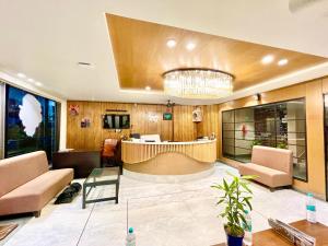 a lobby with a table and chairs and a bar at Near Sea Beach HOTEL RB-INN ! Puri,Near Jagannath Temple- Fully Air conditioned Rooms ,Wifi,- Lift and Restaurant, Parking Facilities - A Top Rated Hotel IN PURI in Puri