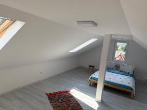 a attic bedroom with a bed and a window at Alex88 in Buşteni