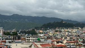 a view of a city with mountains in the background at Suite Stay in Kathmandu