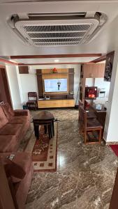 a living room with a couch and a flat screen tv at Suite Stay in Kathmandu