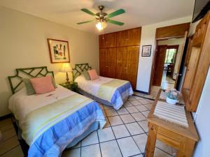 a bedroom with two beds and a ceiling fan at Casa San Miguel in Aguascalientes