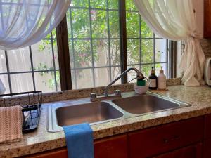a kitchen sink in a kitchen with windows at Casa San Miguel in Aguascalientes +43 photos