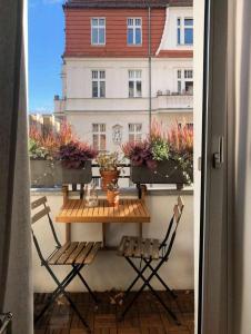 a table and chairs on a balcony with a building at White Brown Apartment in Bangi