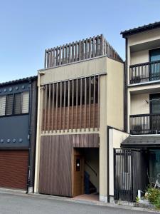 an apartment building with a garage and a building at 城崎 柳通り ゆるり-Yururi- in Toyooka +13 photos