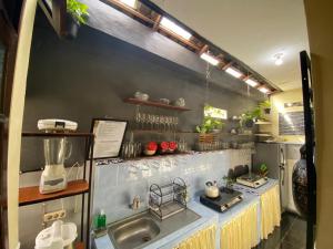 a kitchen with a sink and a counter top at Coliving Bali SWEET HOME Tabanan,Daily & Monthly Stay,Kost Bulanan in Tabanan