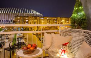 a teddy bear sitting on a balcony with a bowl of fruit at Apartment Zagreb Spirit in Zagreb