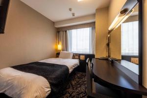 a hotel room with a bed and a desk at APA Hotel Komatsu Grand in Komatsu +52 photos