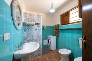 a blue bathroom with a sink and a toilet at Casa Varvodda in San Vito dei Normanni +37 photos