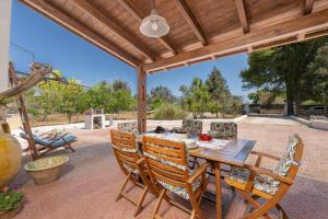 an outdoor patio with a wooden table and chairs at Casa Varvodda in San Vito dei Normanni