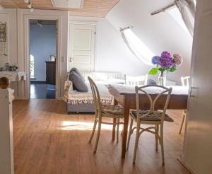 a dining room with a table and chairs and a couch at Blåbjerg Barn in Tønder