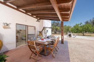 a wooden table and chairs on a patio at Casa Varvodda in San Vito dei Normanni