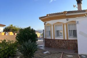 a yellow and white house with a fence at Casa Bueno- Sleeps 7 Private Pool & AirCon in Los Llanos