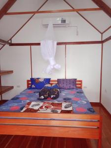 a bedroom with a bed with a canopy at Seabreeze Bangalow in Lagudri +14 photos