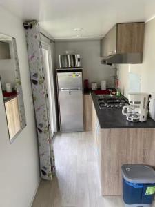 a kitchen with a refrigerator and a counter top at Mobile home with shared pool in Saint-Arnoult in Saint-Arnoult
