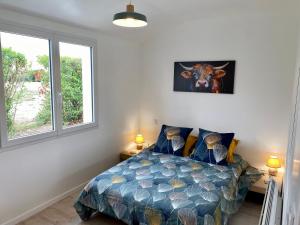 1 dormitorio con 1 cama y una foto de una vaca en la pared en Les Acacias, en Notre-Dame-de-Riez 4 fotos más