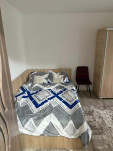 a bed in a bedroom with a wooden frame at Apartament GBY in Drobeta-Turnu Severin